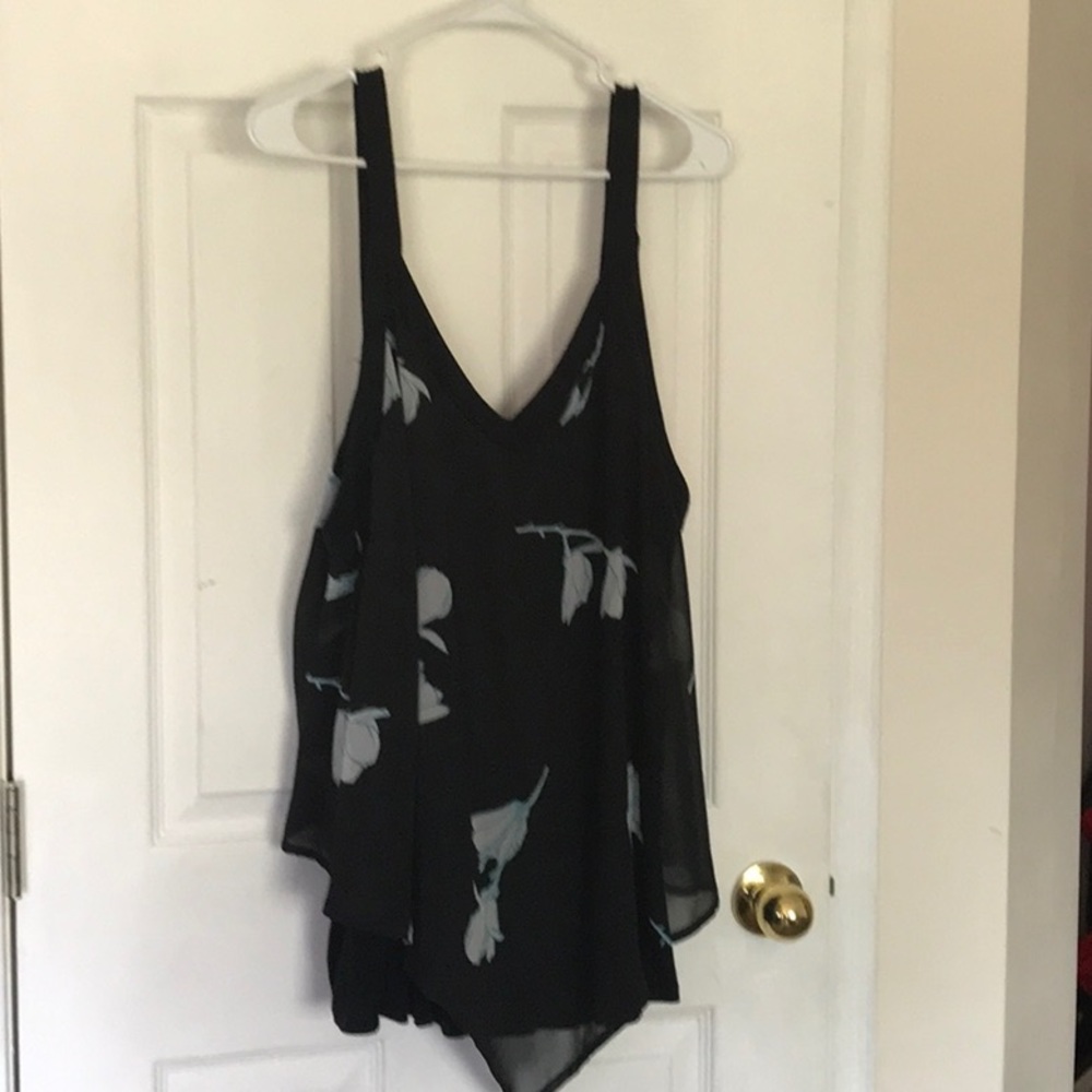 In every story..sleeveless blouse w/ blue feathers